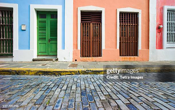 puerto rico, old san juan, door in houses on brick street - puerto rico stockfoto's en -beelden