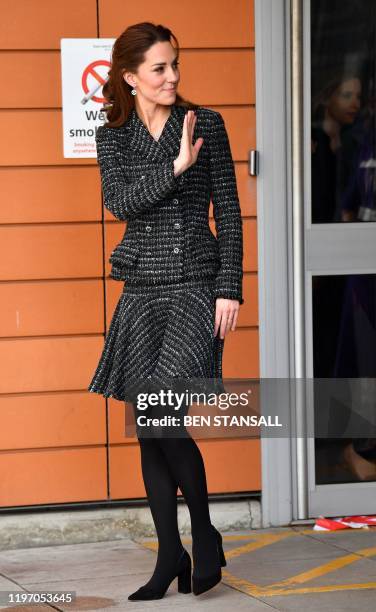 Britain's Catherine, Duchess of Cambridge gestures as she leaves after a visit to the Evelina London Children's Hospital in London on January 28,...