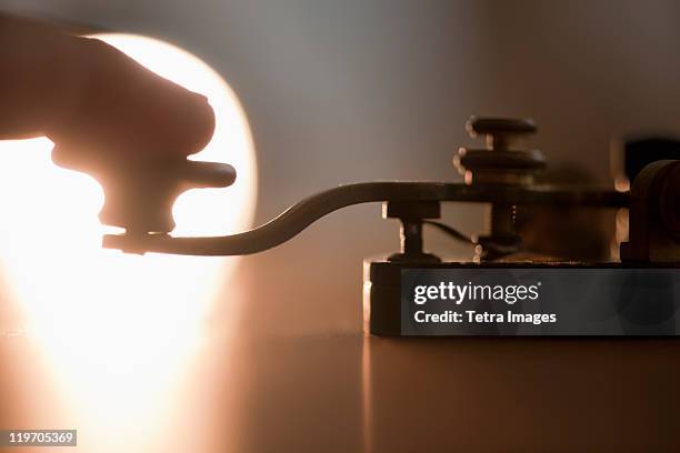 close-up of man using telegraph key - telegraph machine stock pictures, royalty-free photos & images