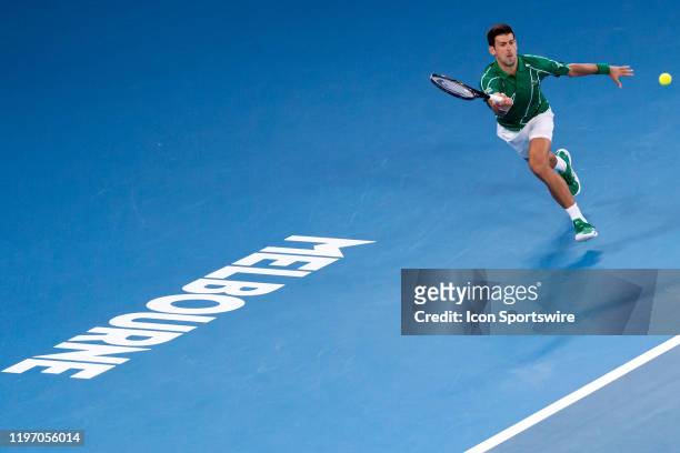 Novak Djokovic of Serbia plays a forehand during quarterfinals of the Australian Open Tennis at Melbourne Park Tennis Centre on January 28, 2020 in...