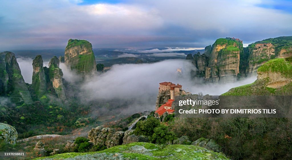 Four Meteora monasteries in mist panorama 2