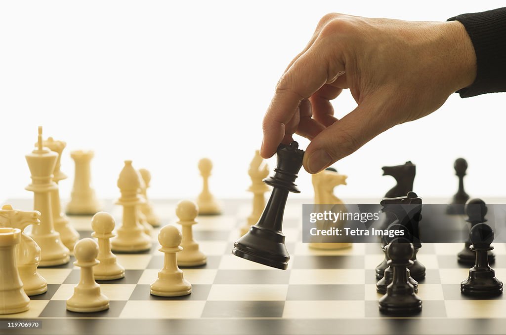 Close-up of man's hand playing chess