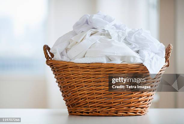 studio shot of laundry basket - waschen stock-fotos und bilder