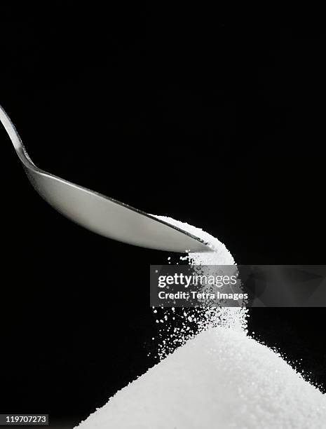 spoon and heap of sugar - sugar stockfoto's en -beelden