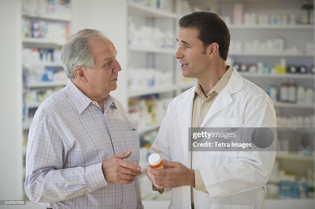 USA, New Jersey, Jersey City, Pharmacist explaining use of medicine to patient