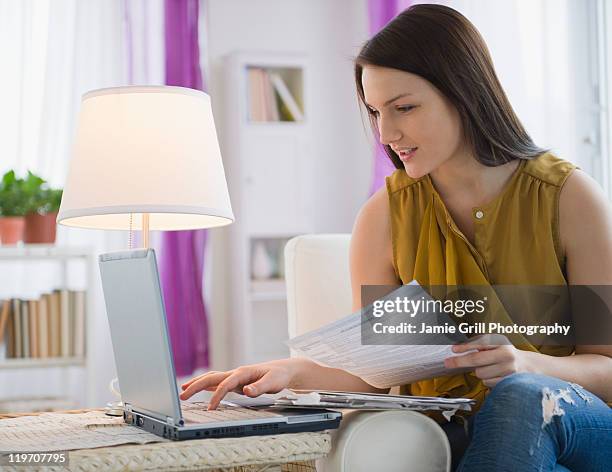 usa, new jersey, jersey city, young woman paying bills on line - long form stock pictures, royalty-free photos & images