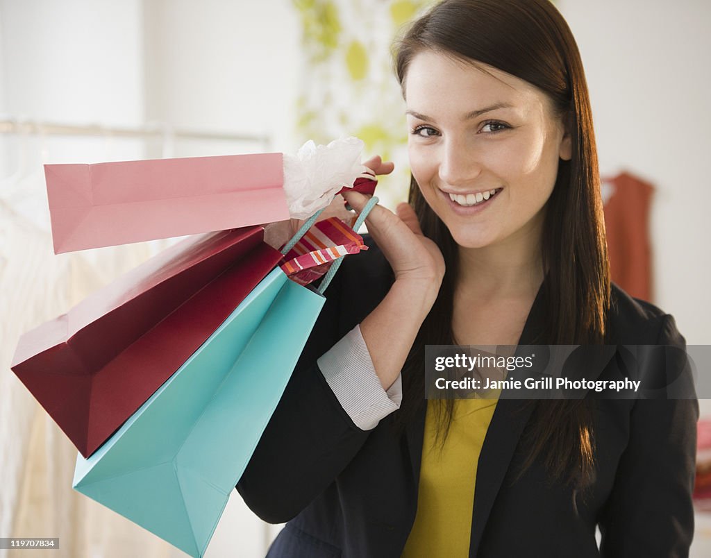 USA, New Jersey, Jersey City, Young woman holding shopping bags