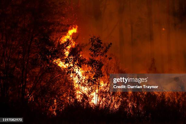 Bushfires burn between the townships of Bemm River and Cann River in eastern Gippsland on January 02 Australia. The HMAS Choules docked outside of...