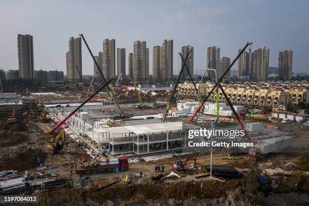 Hundreds of construction workers and heavy machinery build new hospitals to tackle the coronavirus on January 28, 2020 in Wuhan, China. Wuhan...