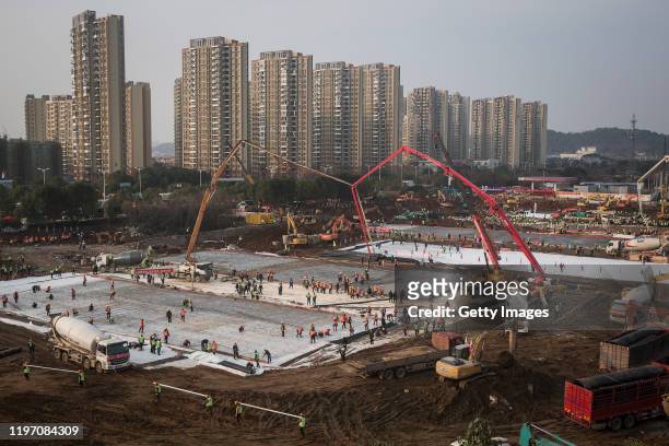 Hundreds of construction workers and heavy machinery build new hospitals to tackle the coronavirus on January 28, 2020 in Wuhan, China. Wuhan...