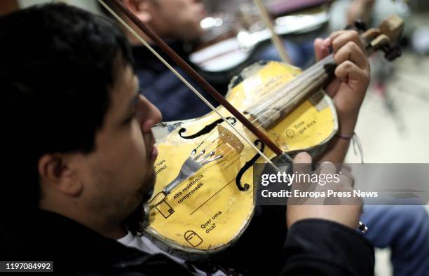 Musician of the ‘Orquesta de Instrumentos Reciclados de Cateura’ , playing his recycled violin during a rehearsal at the Hotel Leonado before the...