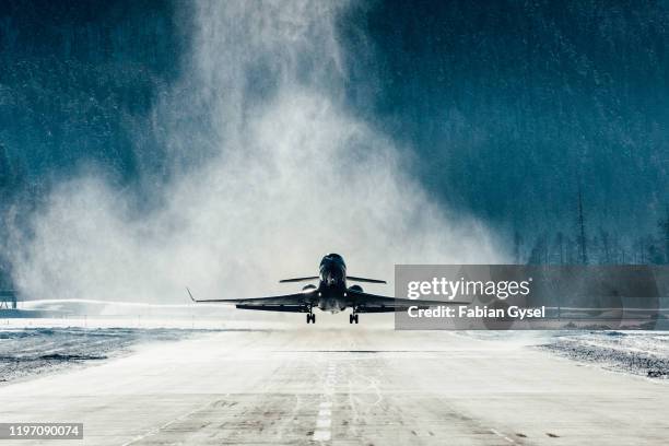 commercial jet departing with snow blasting away - landing touching down stock pictures, royalty-free photos & images