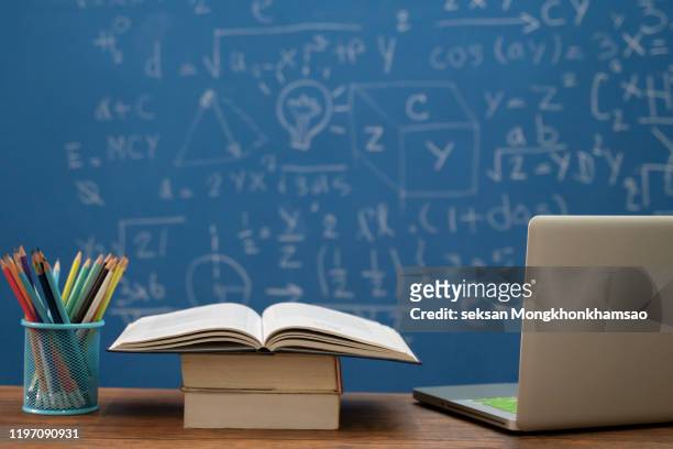 back to school supplies. books and blackboard on wooden background - classroom background fotografías e imágenes de stock