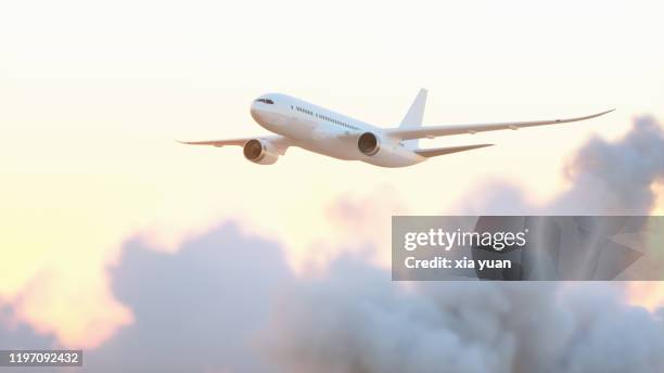 airplane flying above clouds at sunset - airplane take off stock pictures, royalty-free photos & images