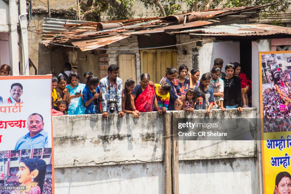 People watching Marbat procession from balcony.