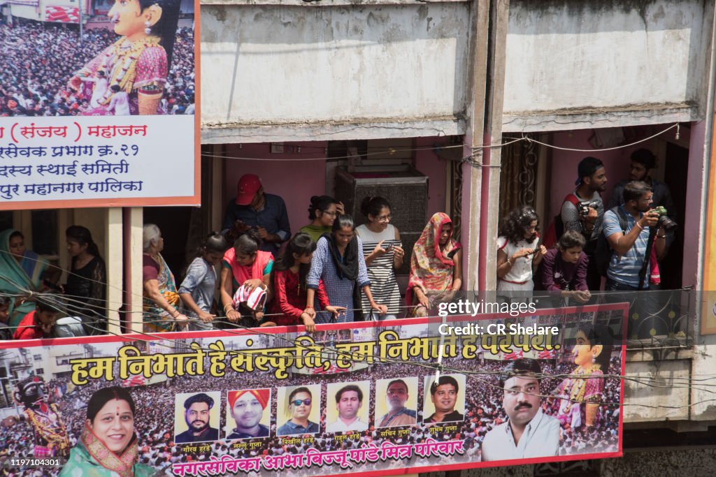 People watching Marbat procession from balcony.