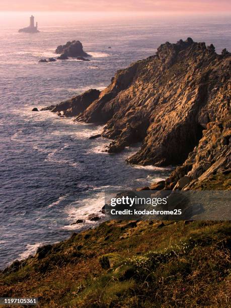 the pointe du raz is a promontory that extends into the atlantic from western brittany, in france. - finistere stock pictures, royalty-free photos & images