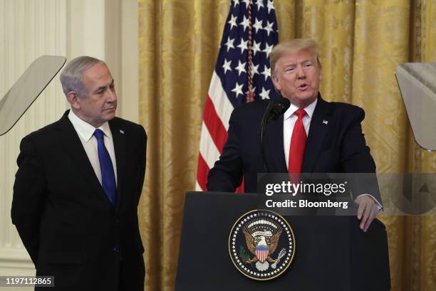 President Donald Trump speaks as Benjamin Netanyahu, Israel's prime minister, left, listens during a news conference in the East Room of the White...
