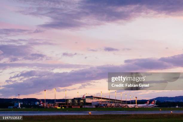 swiss international air lines planes at the gate at sunset - airbus cockpit stock pictures, royalty-free photos & images