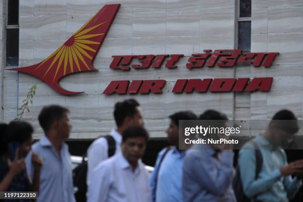 People walk past an Air India logo outside its building in Mumbai, India on 28 January 2020.