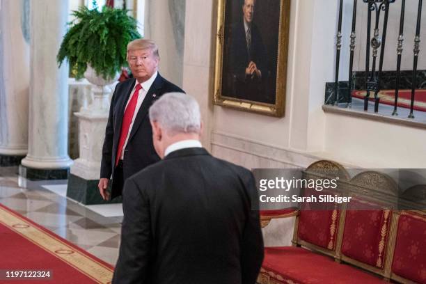 President Donald Trump and Israeli Prime Minister Benjamin Netanyahu depart from a joint statement in the East Room of the White House on January 28,...