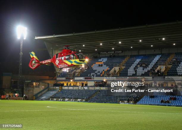 The Thames Valley Air Ambulance helicopter lands on the pitch at Adams Park, home of Wycombe Wanderers during the Sky Bet League One match between...