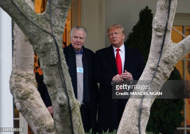 President Donald Trump stands with actor Jon Voight outside the Oval Office before departing from the South Lawn of the White House in Washington, DC...