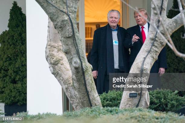 President Donald Trump speaks with American actor Jon Voight outside of the Oval Office before departing from the South Lawn on Marine One on January...