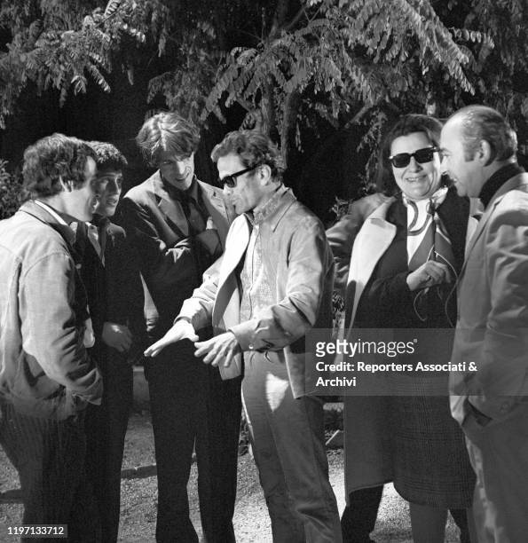Italian writer and director Pier Paolo Pasolini talking to Italian actors Franco Citti and Ninetto Davoli and French actor Laurent Terzieff on the...