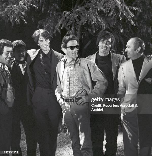 Italian writer and director Pier Paolo Pasolini standing with Italian actors Franco Citti and Ninetto Davoli and French actor Laurent Terzieff on the...