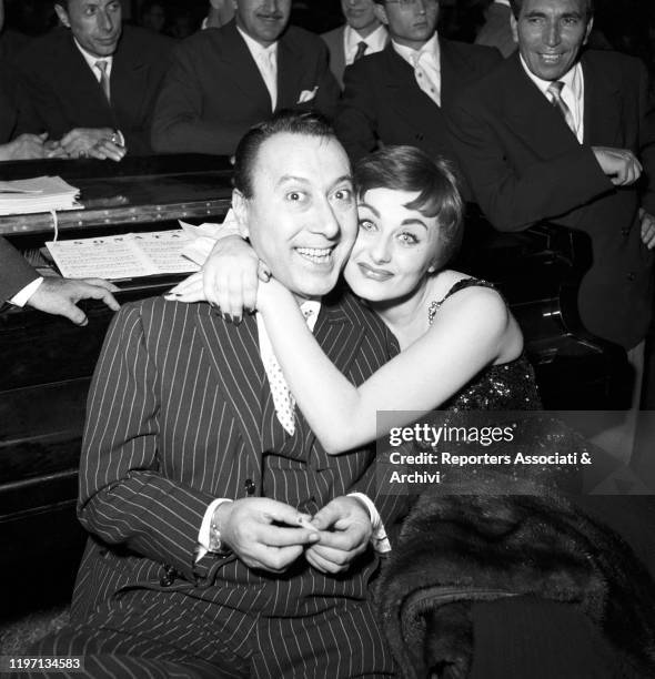 Italian actress Sandra Mondaini hugging Italian actor Macario at the Maschere d'Argento awarding ceremony in EUR district. Rome, 13th September 1955