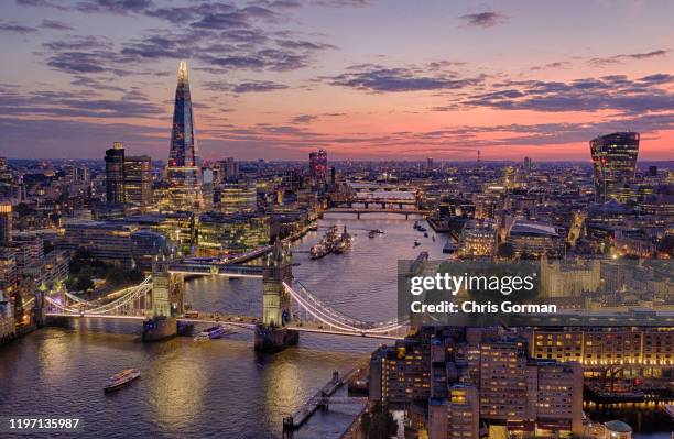 The summer sky sets behind the city of London on a Saturday night on July 13, 2019 in London, United Kingdom. Tower Bridge, The Tower of London and...