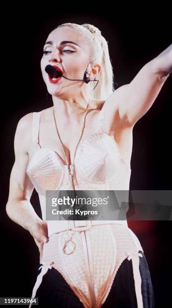 American singer and actress Madonna in concert, wearing her iconic cone bra, circa 1990.