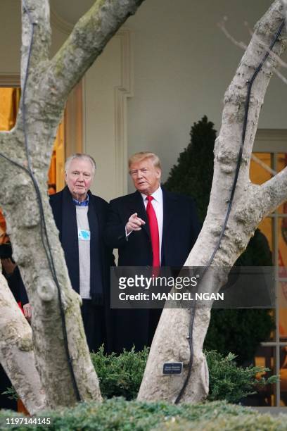President Donald Trump is seen outside of the Oval Office with actor Jon Voight before boarding Marine One before departing from the South Lawn of...