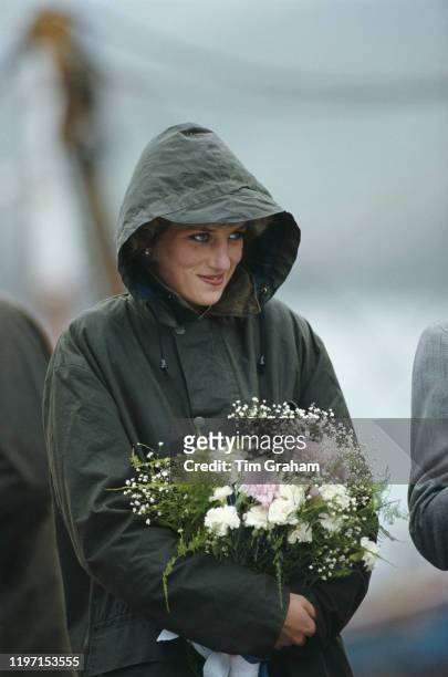 Princess Diana in Ardveenish, in the Western Isles of Scotland, July 1985. She is keeping dry in a green Barbour coat.