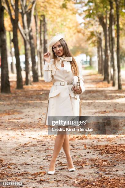 Digital influencer Karolina Zubkova Mattes wears a Chanel belt and bag, Dior jacket, Gianvito Rossi shoes, Chanel bag, Elie Saab earrings and Philip...