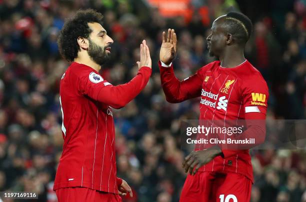 Mohamed Salah of Liverpool celebrates with Sadio Mane after scoring his team's first goal during the Premier League match between Liverpool FC and...