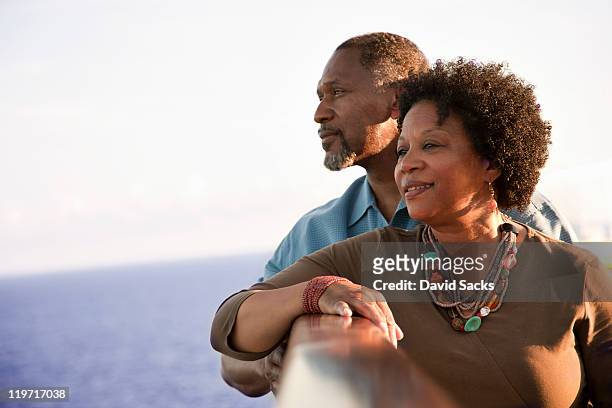 couple on deck looking into the ocean - contemplation couple fotografías e imágenes de stock