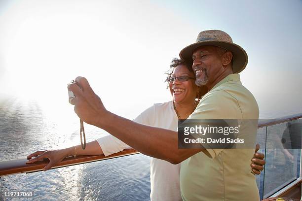 couple on deck taking picture - cruise deck stock pictures, royalty-free photos & images