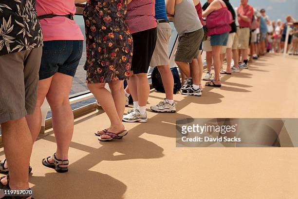 row of people on deck - fat people stock pictures, royalty-free photos & images