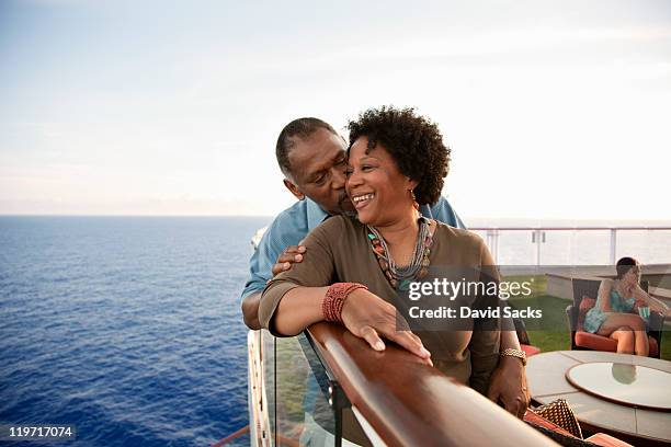 couple on railing on deck - cruise stockfoto's en -beelden