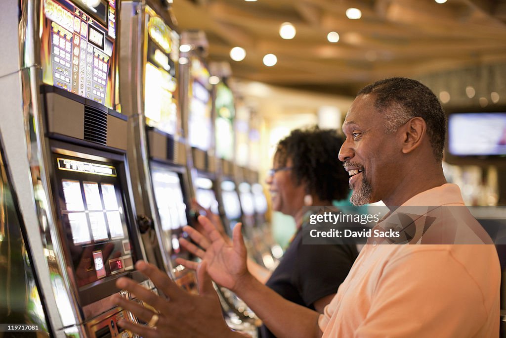 Man and woman on slot machine
