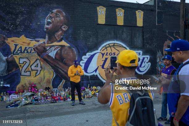 Fans visit a mural of former NBA star Kobe Bryant who, along with his 13-year-old daughter Gianna, died January 26 in a helicopter crash, on January...
