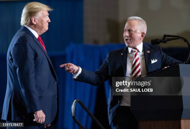 Representative Jeff Van Drew , who recently switched parties, gestures toward US President Donald Trump during a "Keep America Great" campaign rally...