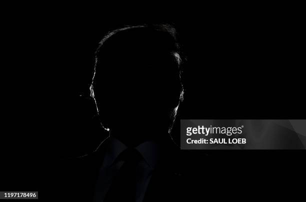 President Donald Trump's silhouette is seen during a "Keep America Great" campaign rally at Wildwoods Convention Center in Wildwood, New Jersey,...