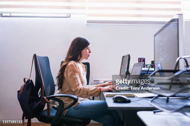 Young woman architect working on computer in office