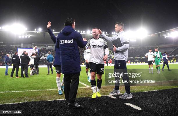 Wayne Rooney of Derby County walks off the pitch after making his debut as Shay Given, Head goalkeeping coach pats him on the back after the Sky Bet...