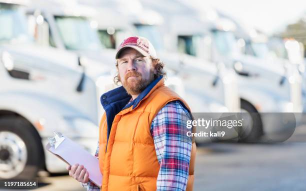 man standing in front of semi-truck fleet - fleet owner stock pictures, royalty-free photos & images