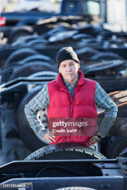 man standing in the middle of a semi-truck fleet - fleet manager stock pictures, royalty-free photos & images