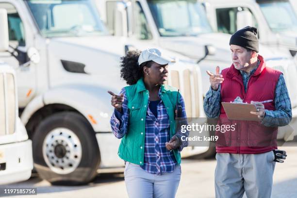 truck drivers with fleet of semi-trucks - fleet of vehicles stock pictures, royalty-free photos & images